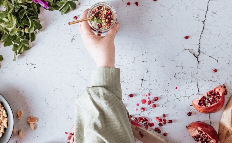 Pomegranate with yogurt, granola, and mint.